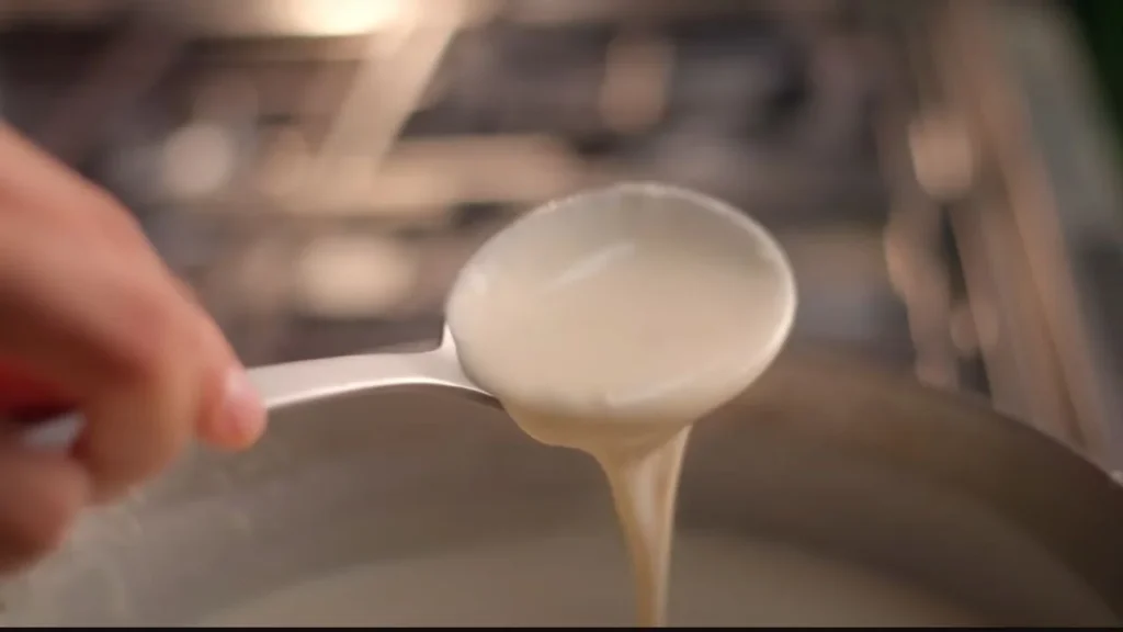 a spoon with liquid flowing from it, Creamy mushroom with lemon Coriander rice