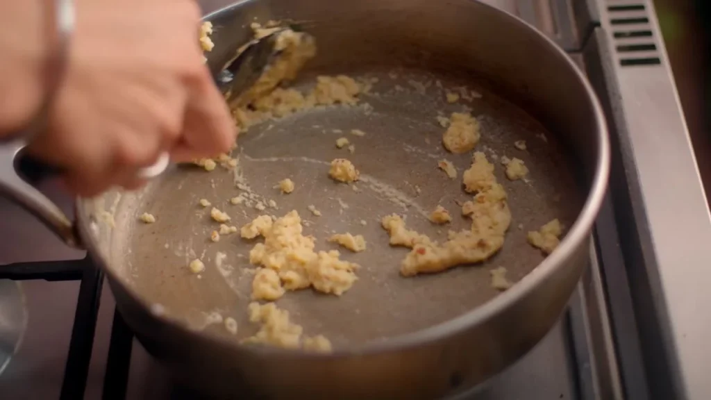 a person stirring food in a pan, Creamy mushroom with lemon Coriander rice