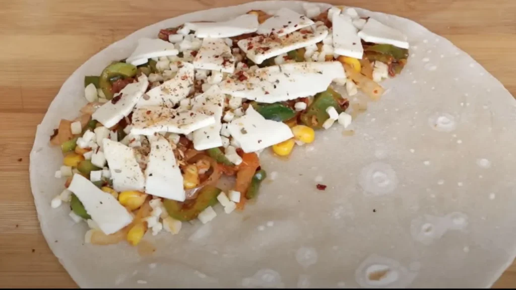 a tortilla with cheese and vegetables, veg quesadilla recipe